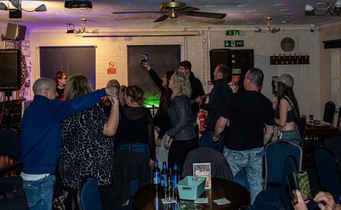 Hybryd Band performing live punk rock gig to a crowd in Chichester
