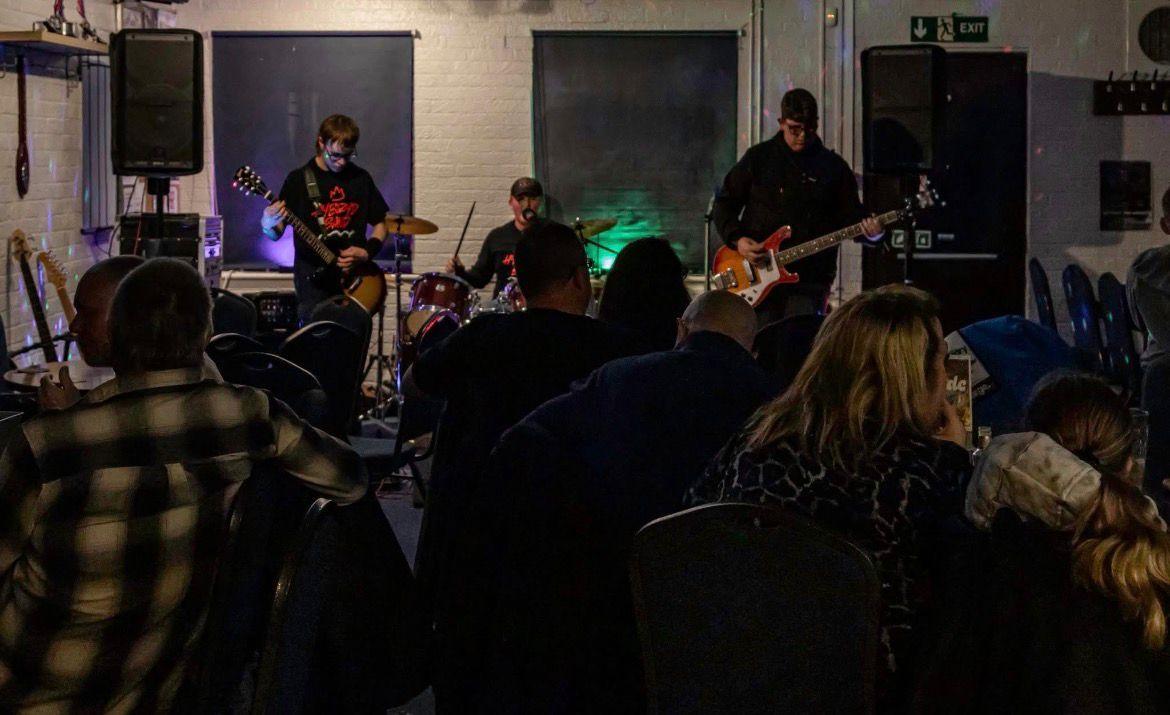 Hybryd playing a live punk rock set to a crowd in West Sussex